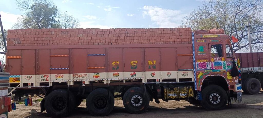 Truck delivering Karimnagar red bricks in Hyderabad Telangana